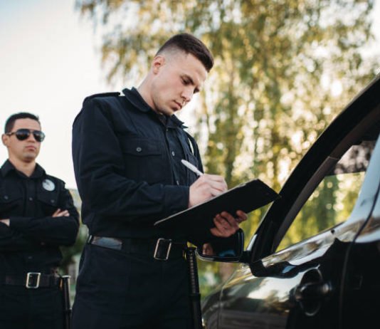 Police officers writing an arrest report.