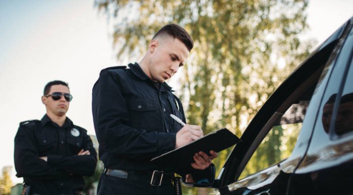 Police officers writing an arrest report.
